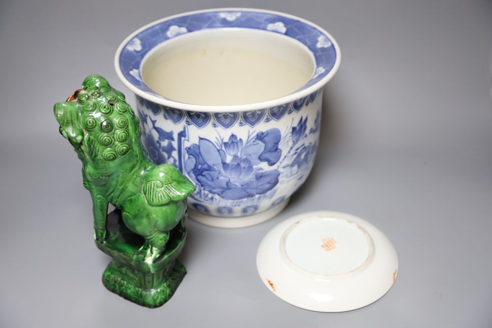 A Chinese blue and white jardiniere, a green glazed lion dog and a famille rose dish